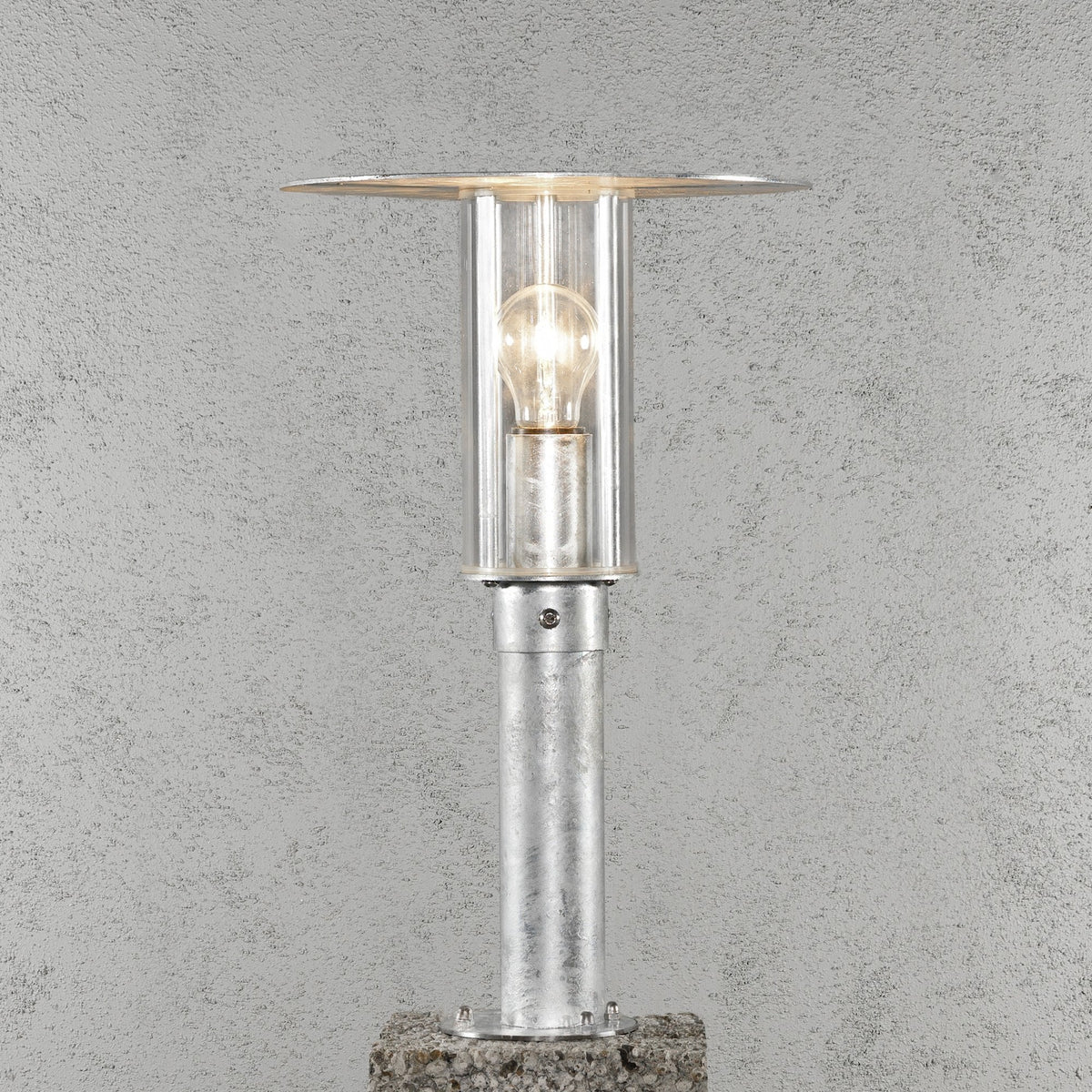 The bollard lamp on a concrete surface.
