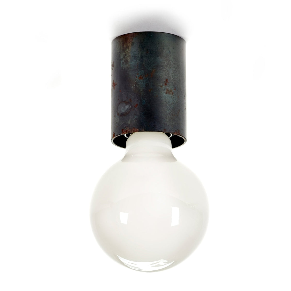 A single globe light bulb with a frosted white finish, attached to a dark, rusted metal base.