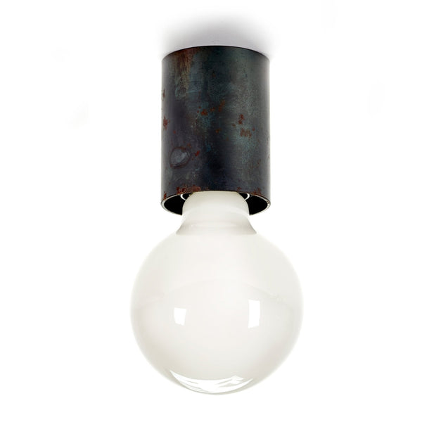 A single globe light bulb with a frosted white finish, attached to a dark, rusted metal base.