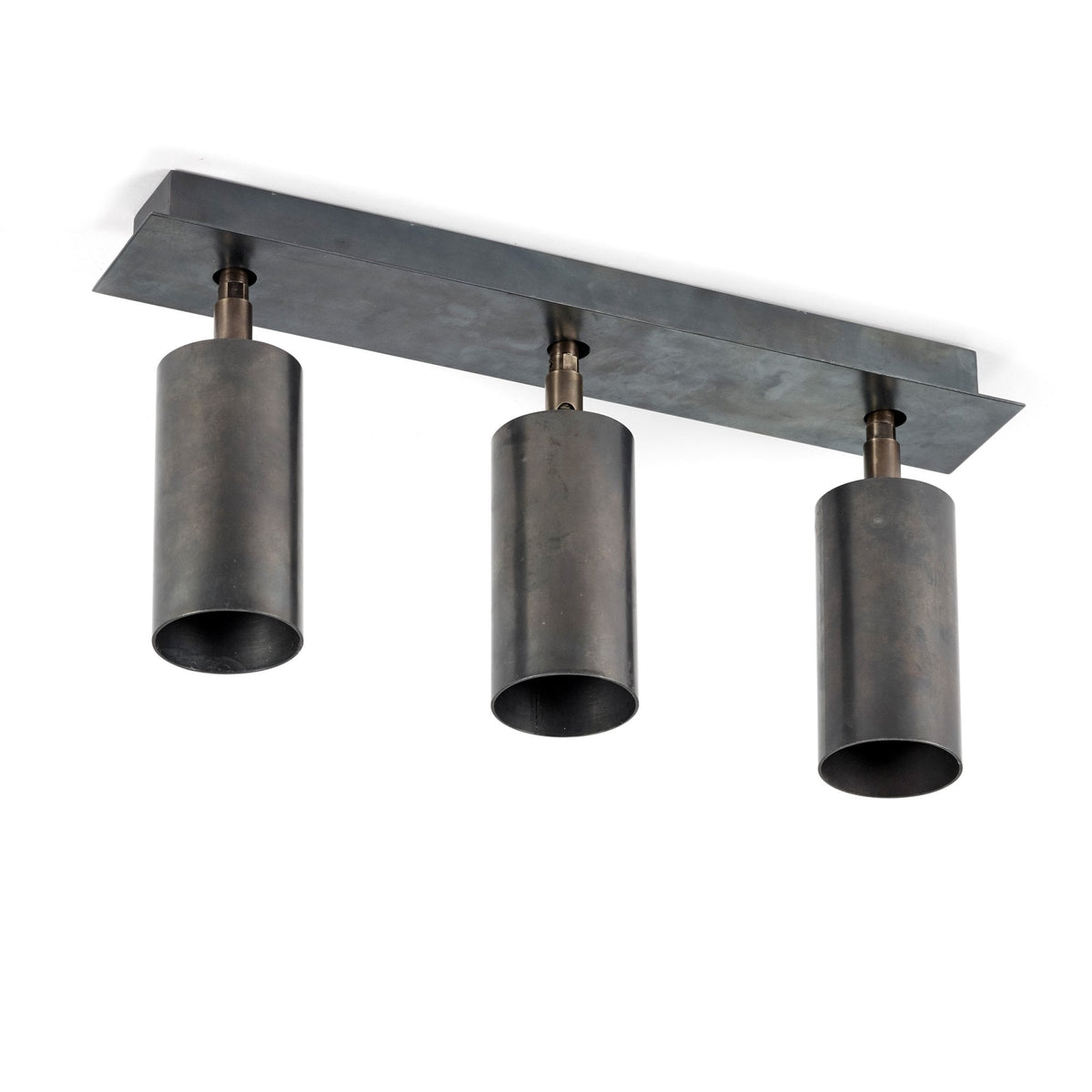 A close-up of a three-spotlight ceiling fixture in a dark, weathered metal finish.
