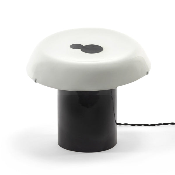 A modern mushroom-shaped lamp with a dark base and a white, opaque shade.