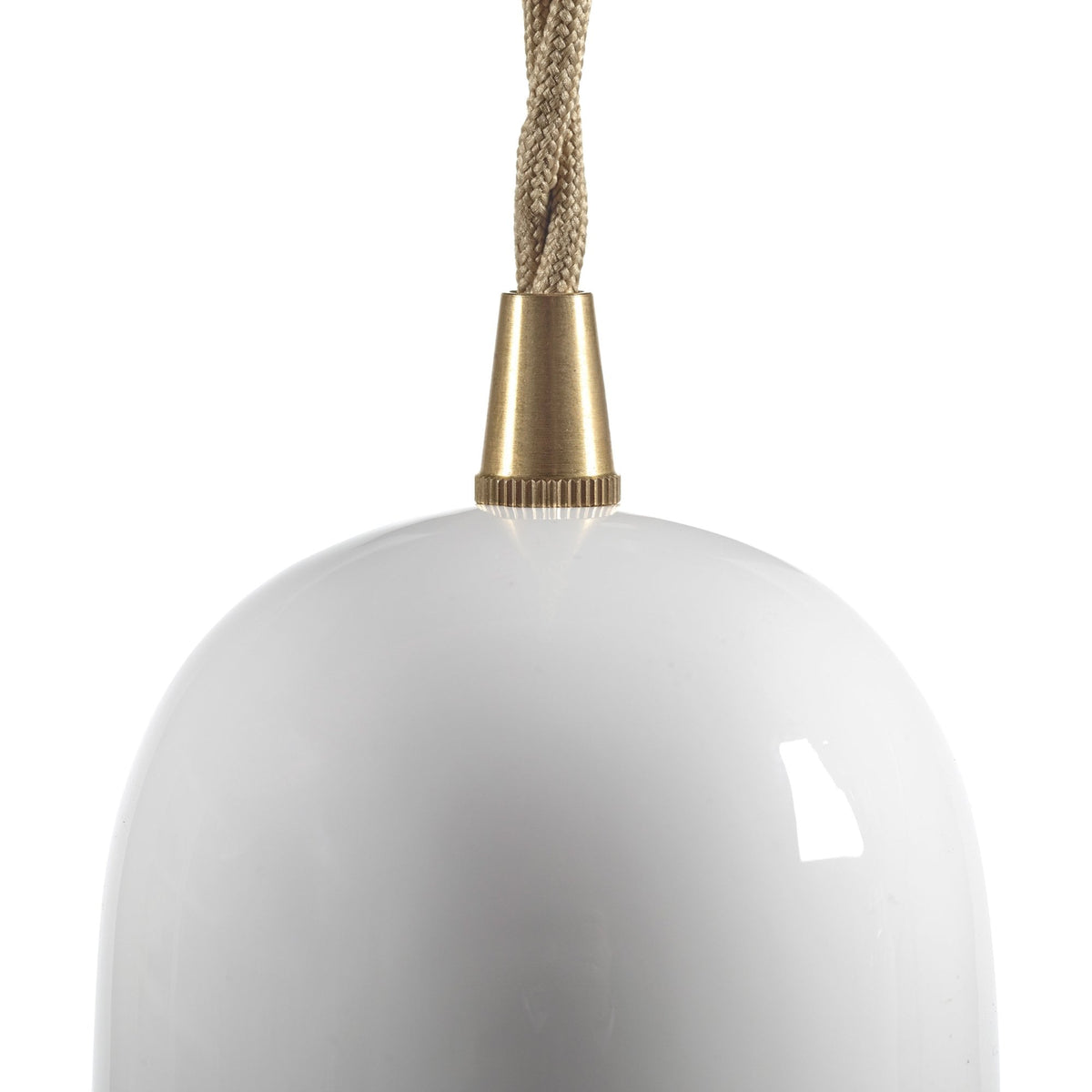 Close-up of the brass top and twisted cord of a white glass pendant light.