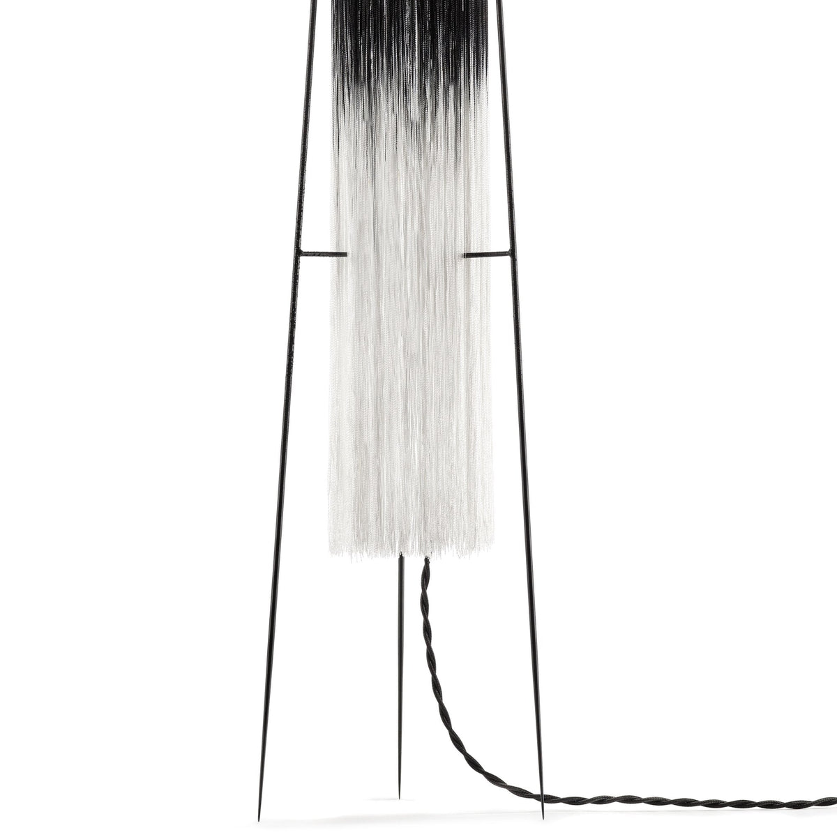 A close-up of the lamp's white shade and braided power cord.