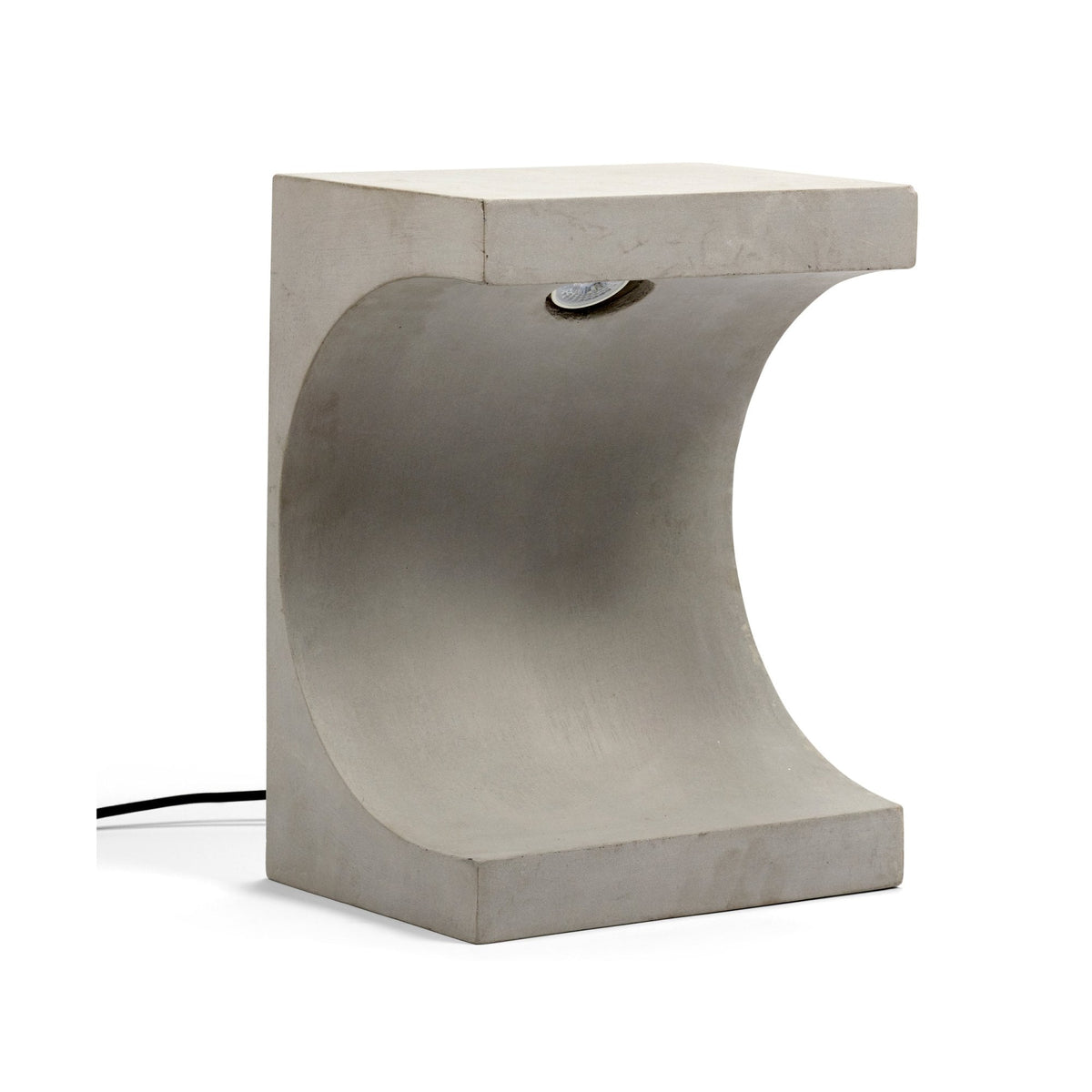 Concrete table lamp with a curved internal shape and an integrated light source.