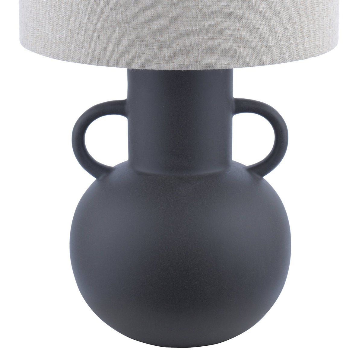 Close-up of the base and shade of a dark grey amphora-shaped table lamp with a light fabric shade.