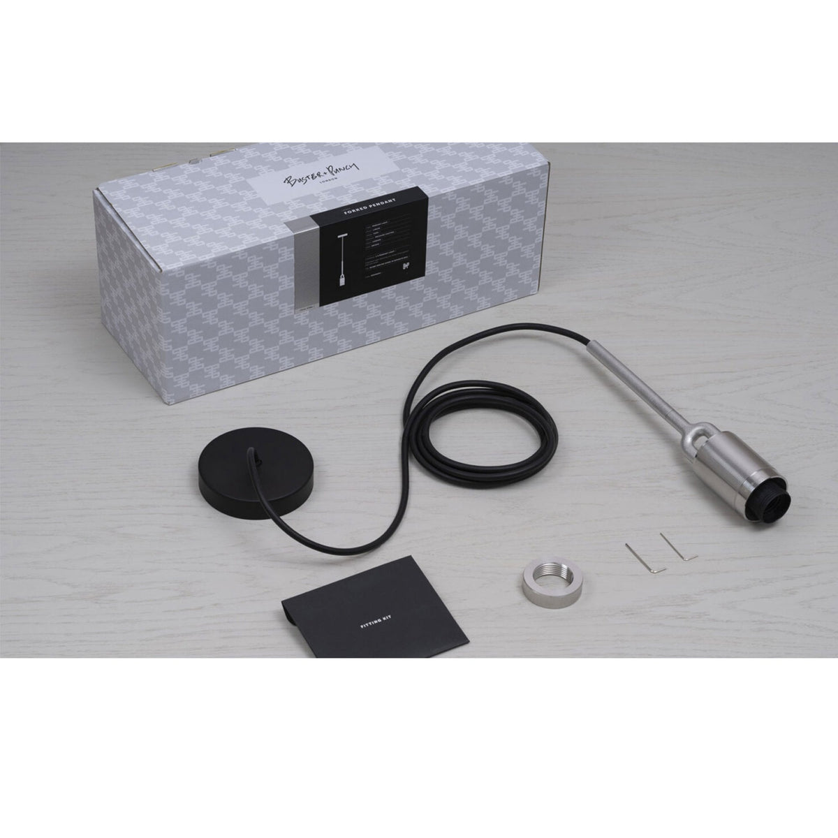 Buster + Punch pendant light kit with a box, black cable, ceiling rose, and metal components.