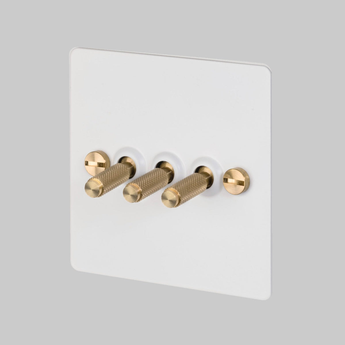 Three Gang 2-Way Light Switch in White & Brass with Knurled Toggles