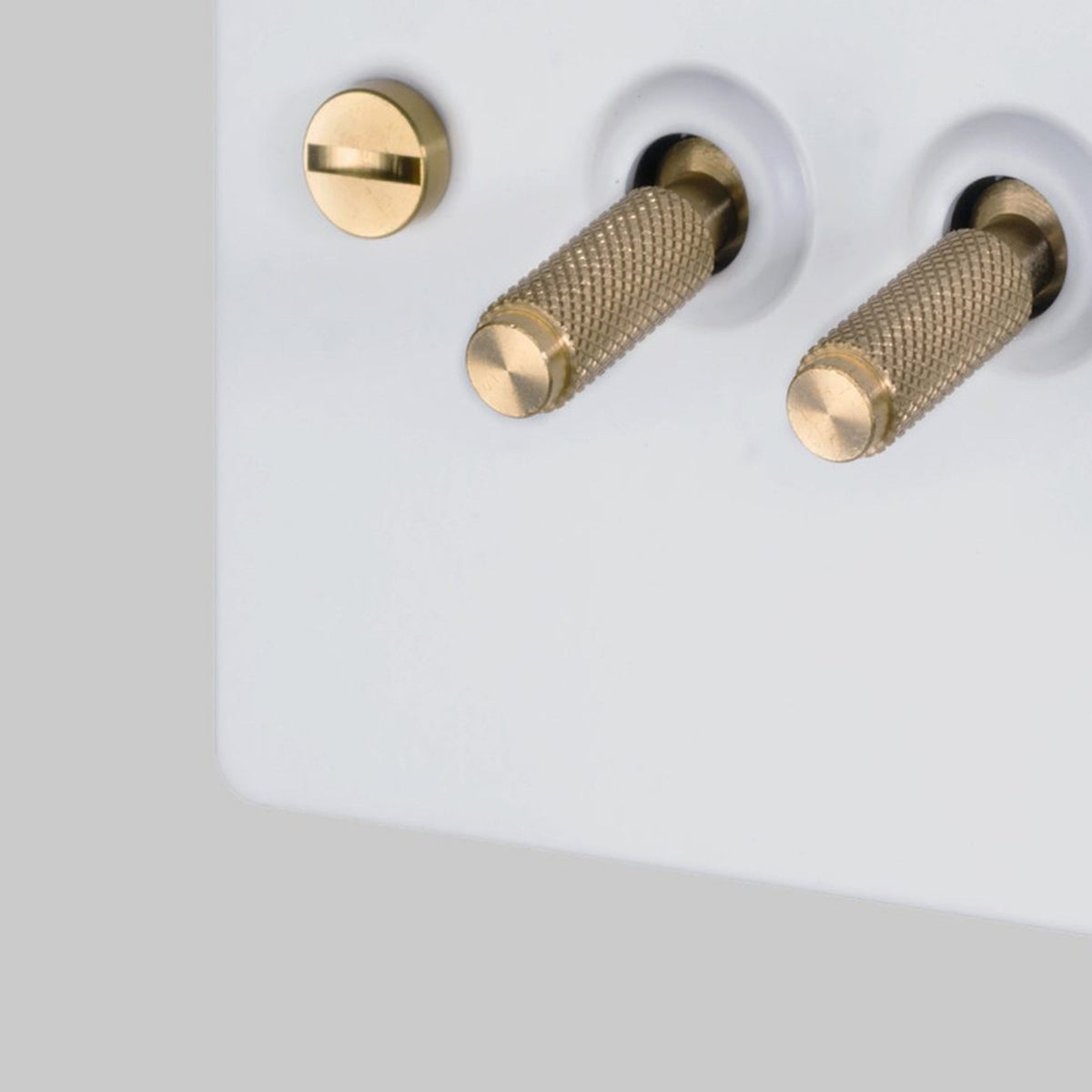 Four Gang 2-Way Light Switch in White & Brass with Knurled Toggles