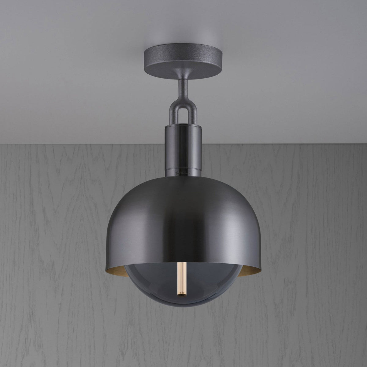 Modern dark grey ceiling light with a semi-spherical shade and a clear glass dome, revealing a vertical bulb.