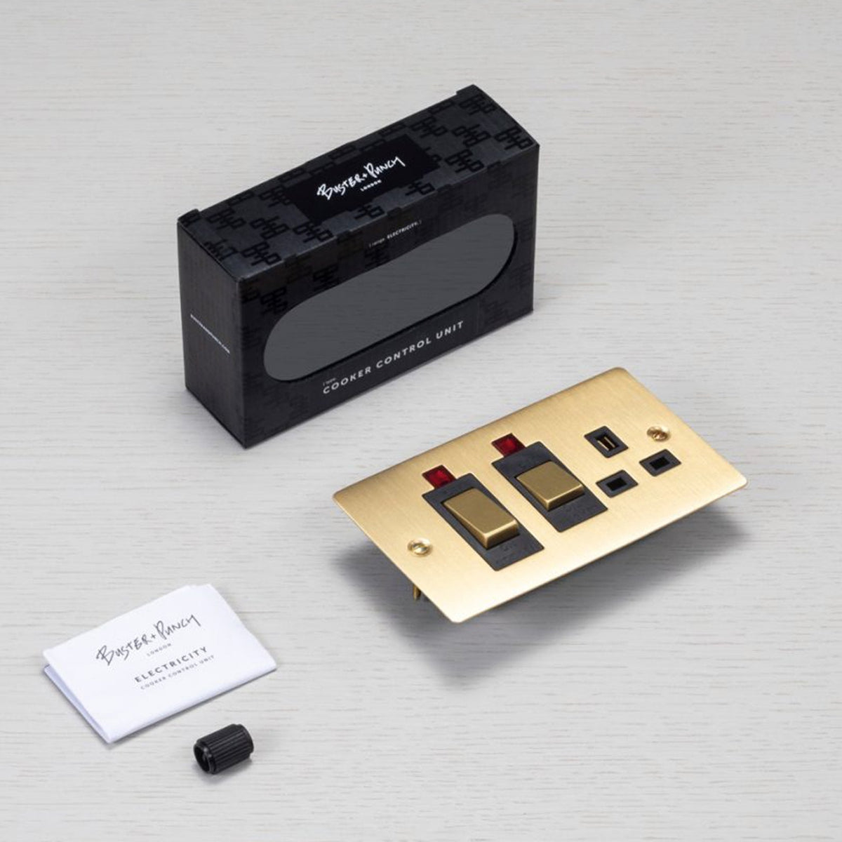 Copper cooker switch and power outlet with USB on a wooden background.