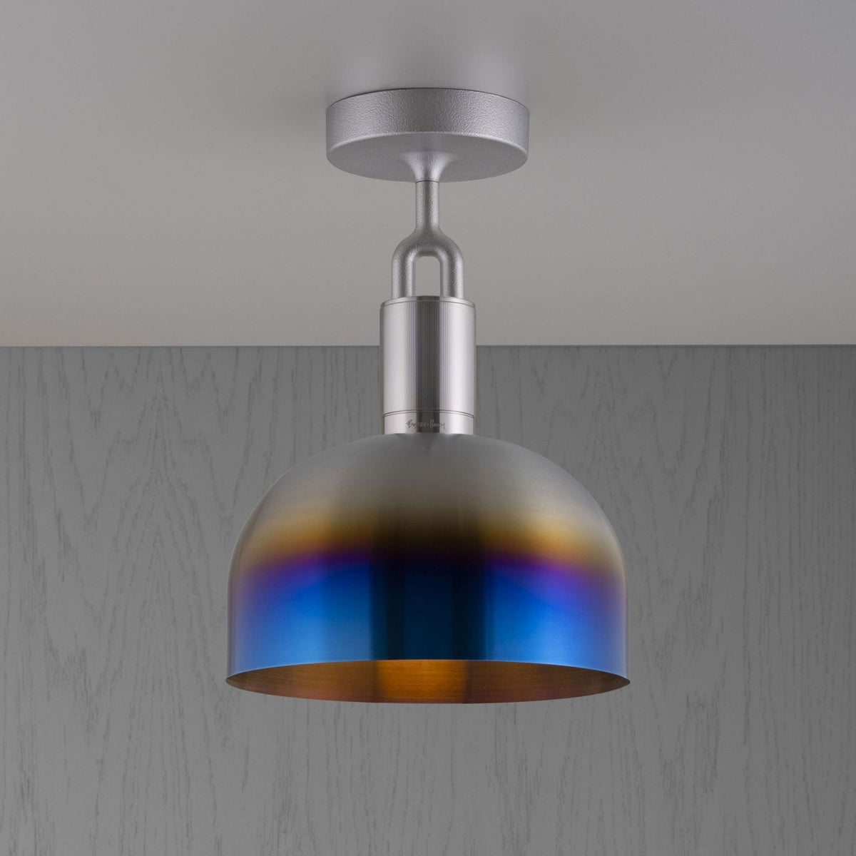 A ceiling light with a silver base and a dome-shaped shade that transitions from silver to blue and gold.