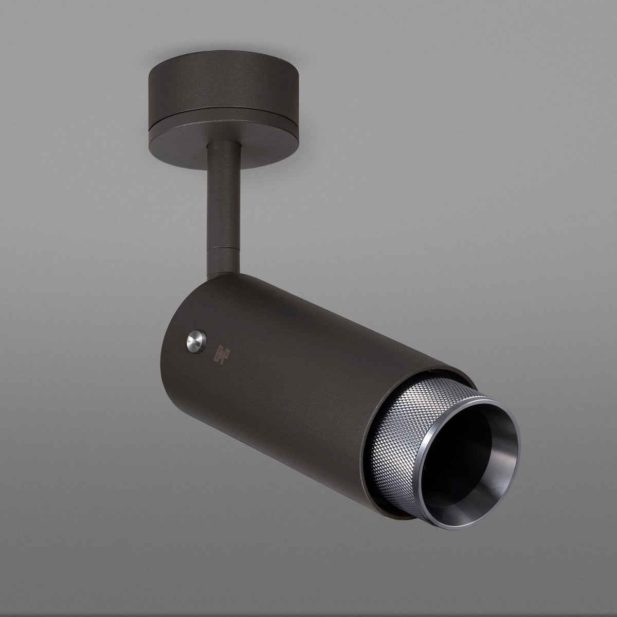Dark grey ceiling spotlight with a textured silver inner reflector, angled downwards.