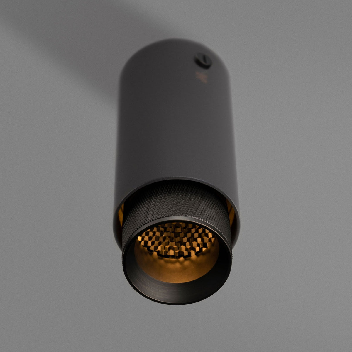 Exhaust Surface Mounted Downlight in a Graphite Finish with Smoked Bronze Detail