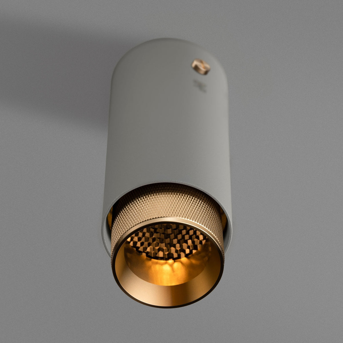 Exhaust Surface Mounted Downlight in a Stone Finish with Brass Detail
