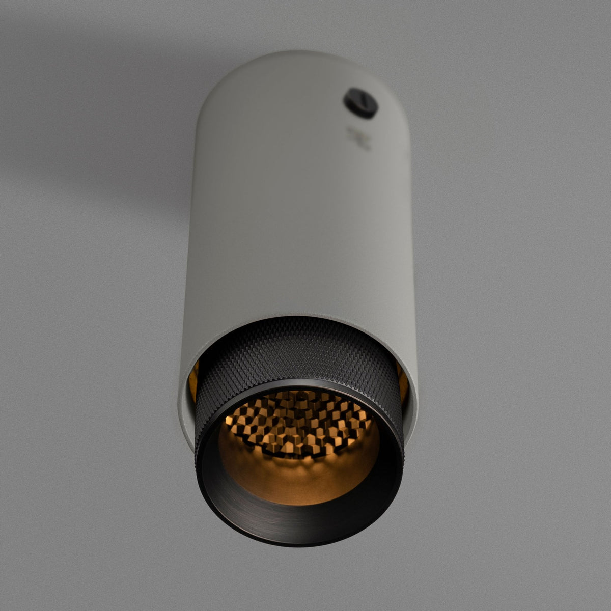 Exhaust Surface Mounted Downlight in a Stone Finish with Smoked Bronze Detail