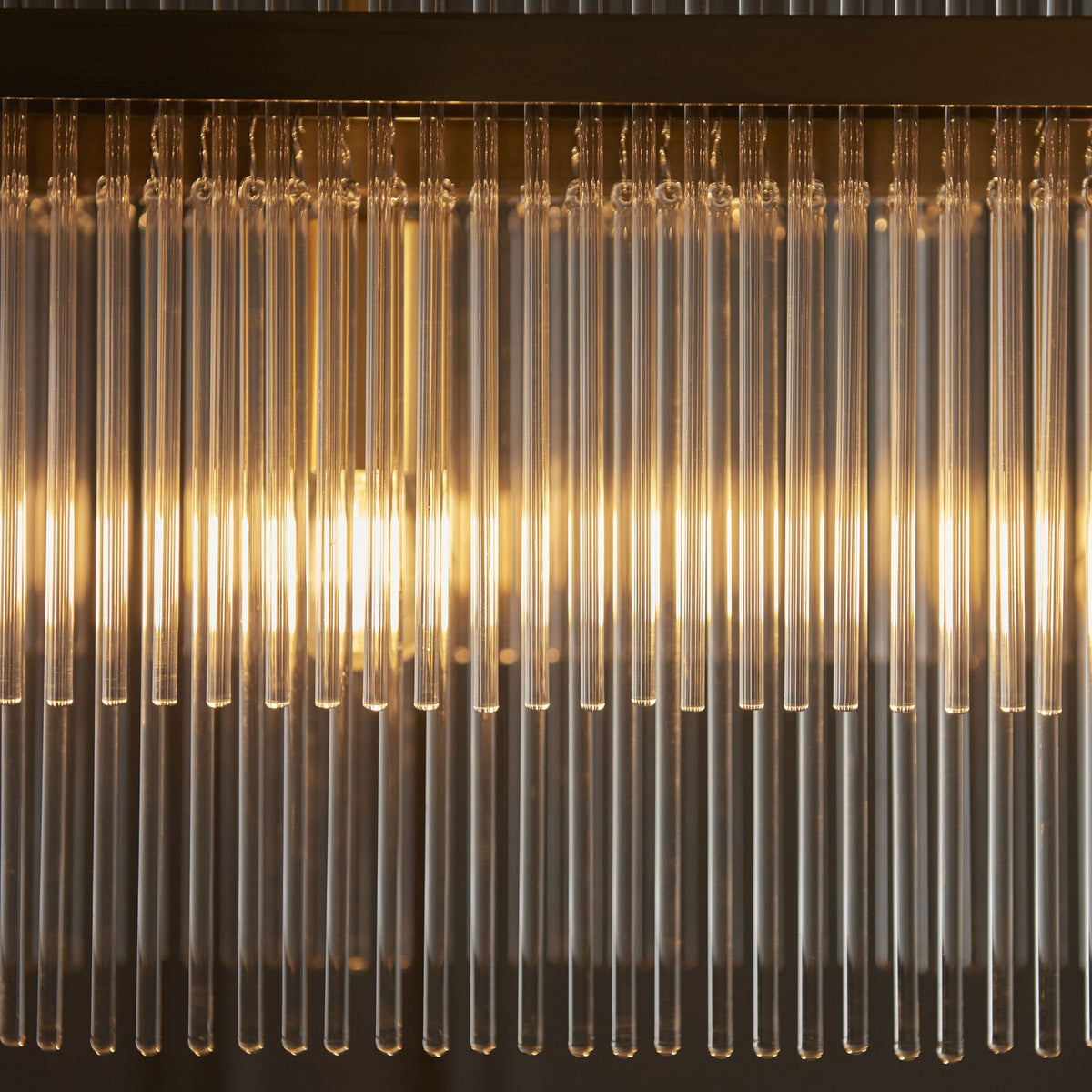 Marietta Four Light Linear Pendant Chandelier in Antique Brass with Clear Glass Rods