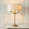 Highclere Three Light Table Lamp in Vintage Brass with Natural Shade