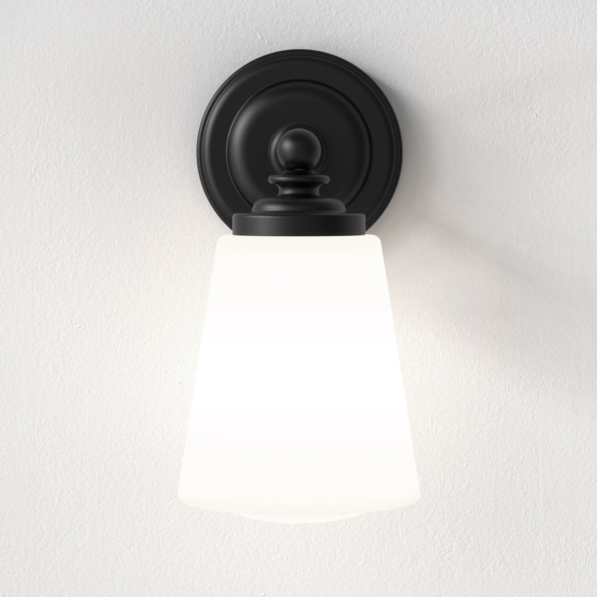 Black wall sconce with a white conical glass shade