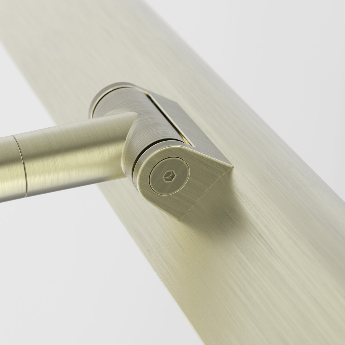 Close up of a brushed brass handrail bracket and a handrail