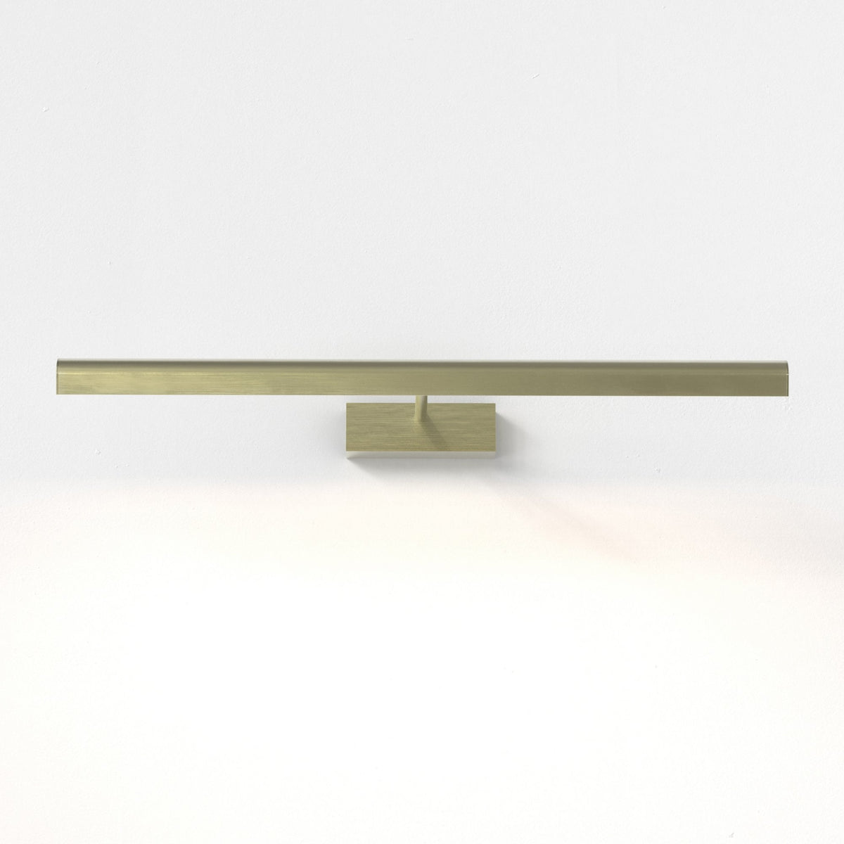 Brass picture light with a rectangular base and a long, horizontal bar extending from it, mounted on a white wall