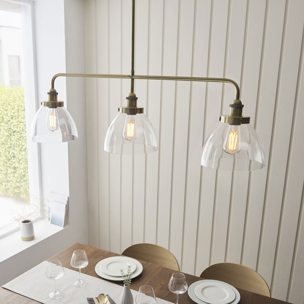 Hansen Triple Light Linear Pendant in Antique Brass and Clear Glass Shades