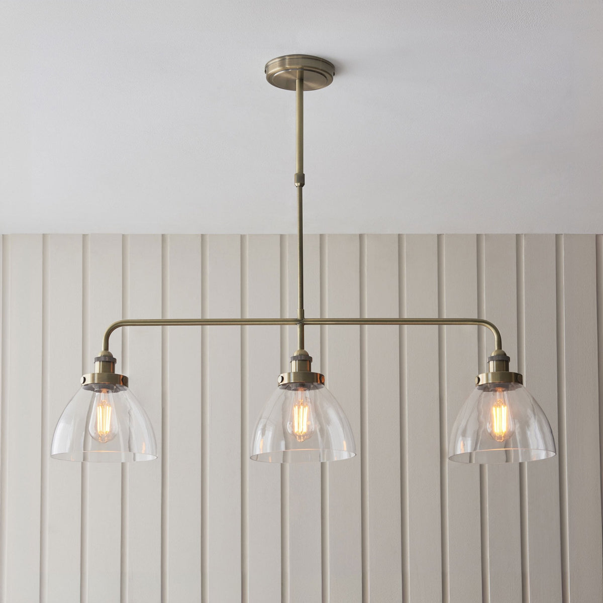 Hansen Triple Light Linear Pendant in Antique Brass and Clear Glass Shades
