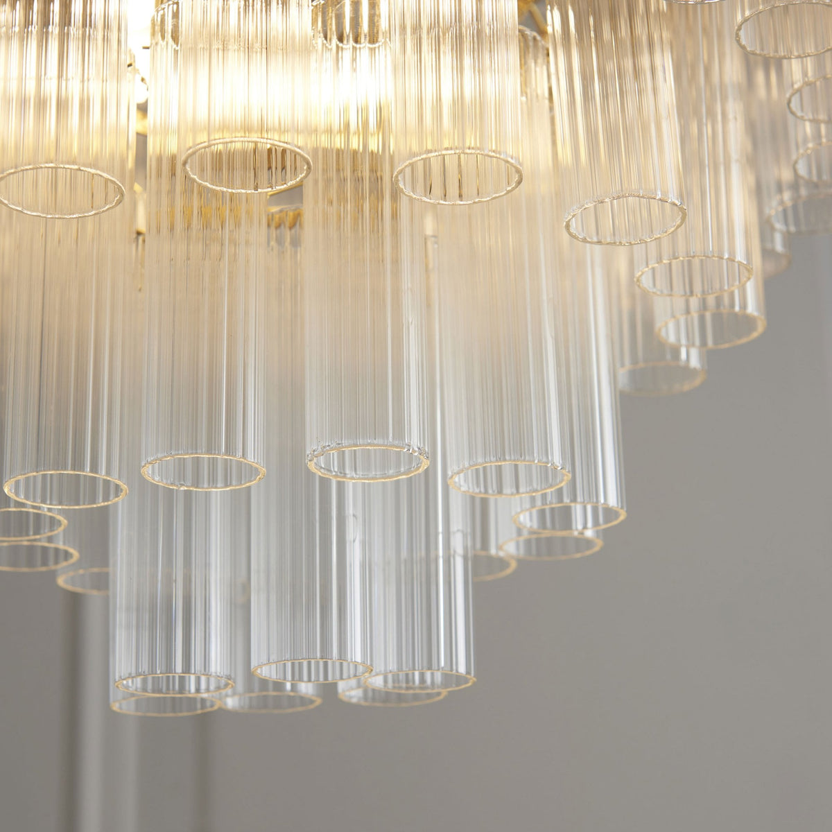 Toulouse Twelve Light Tiered Pendant in Brushed Gold with Ribbed Cylindrical Clear Glass