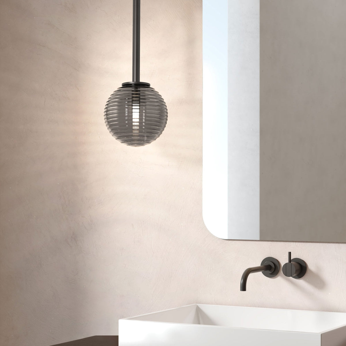 Modern bathroom with a ribbed glass pendant light, a rectangular mirror, and a white sink with a black faucet