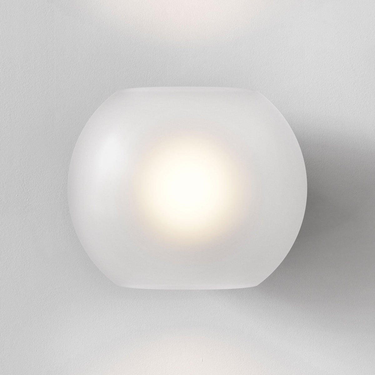 Frosted glass wall sconce with a warm glow