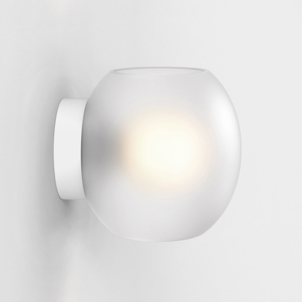 White frosted glass wall light with a circular base and a glowing bulb inside