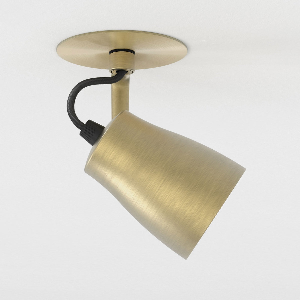 Brushed brass ceiling spotlight with a black braided cable