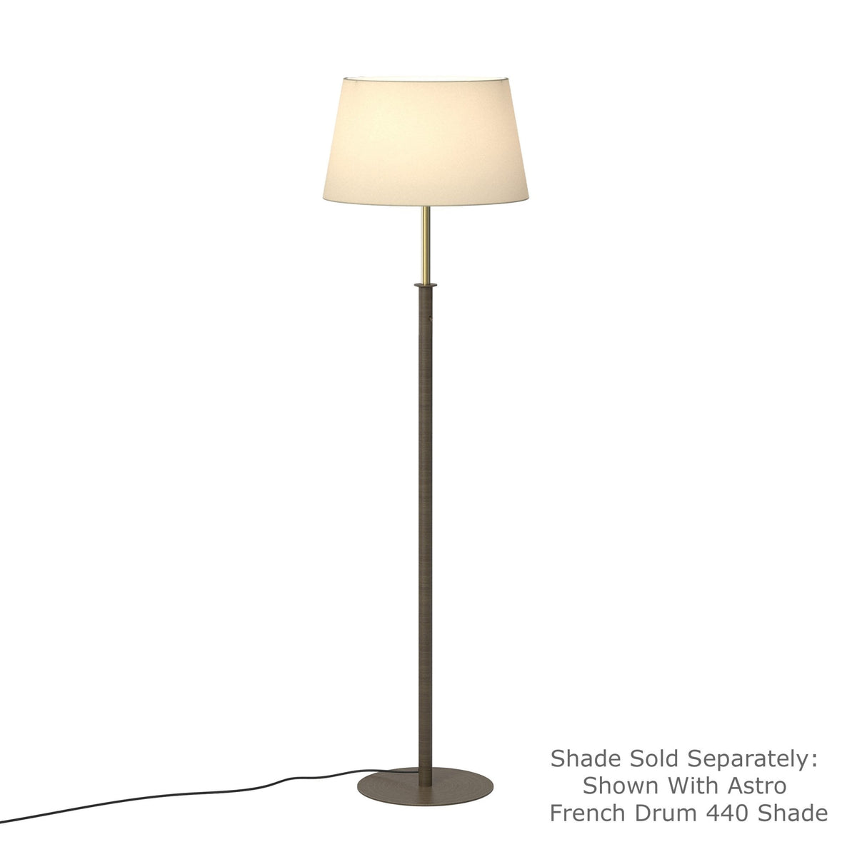 Tall floor lamp with a bronze base and stem, topped with a cream-colored drum shade
