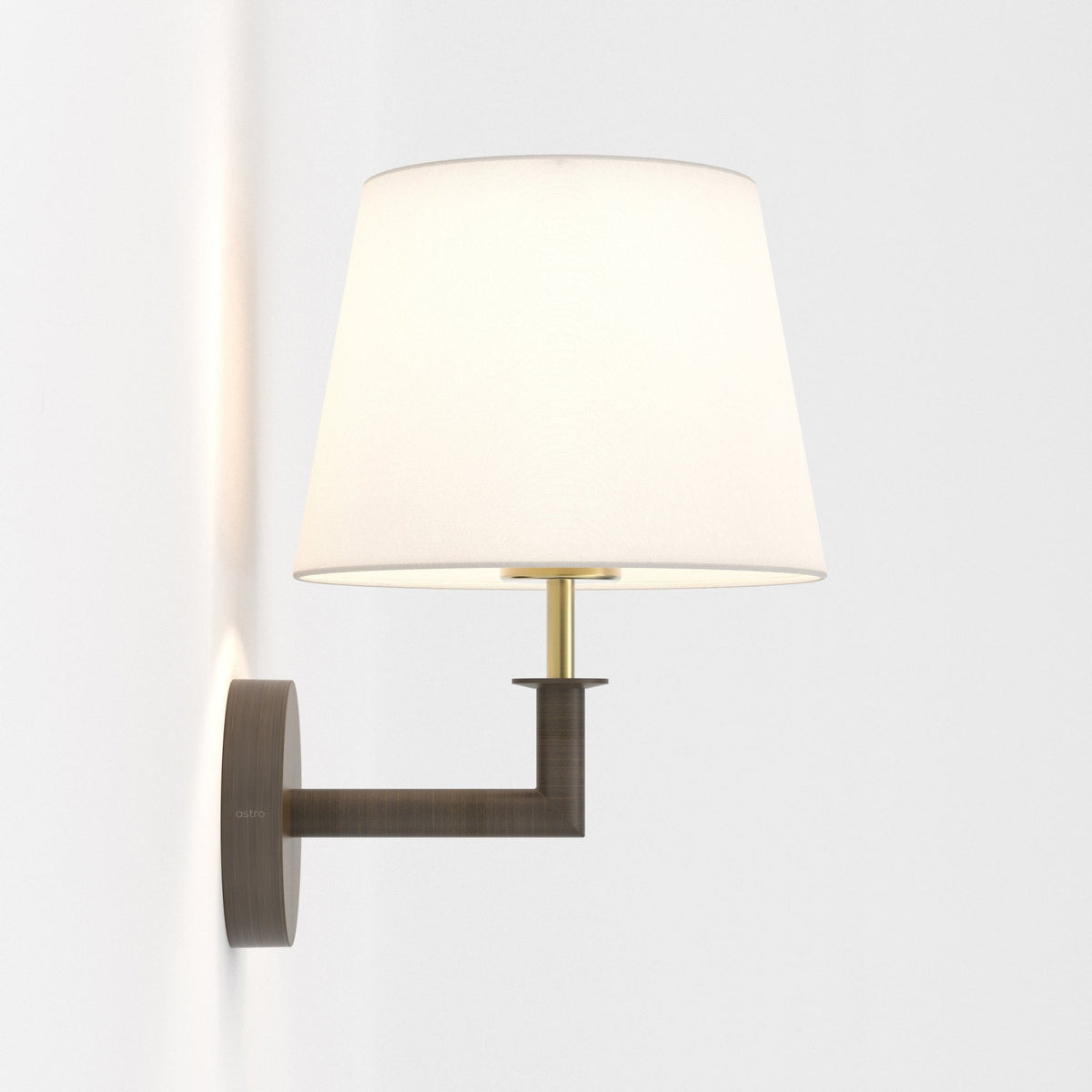 Astro wall light with a white fabric shade and a bronze finish arm