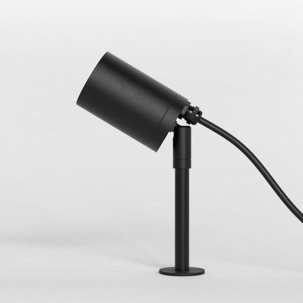 A black outdoor spotlight on a short, adjustable stand, with a discreet power cable.