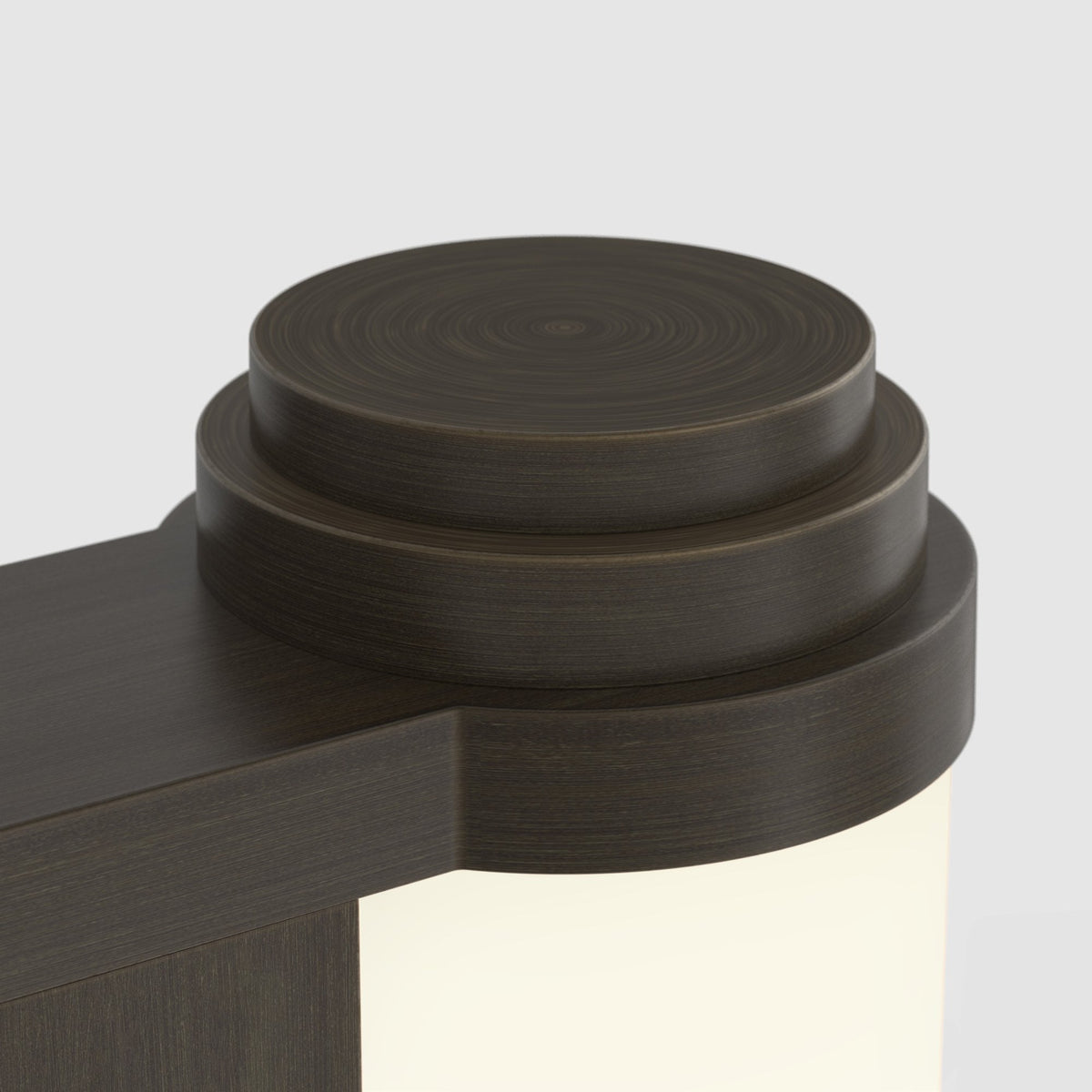 Close up of a dark brown wooden light fixture with a circular top and a glowing light panel