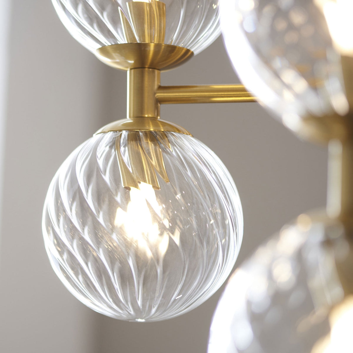 Selston Twelve Light Tiered Pendant in Brushed Aged Brass with Clear Twisted Pattern Glass