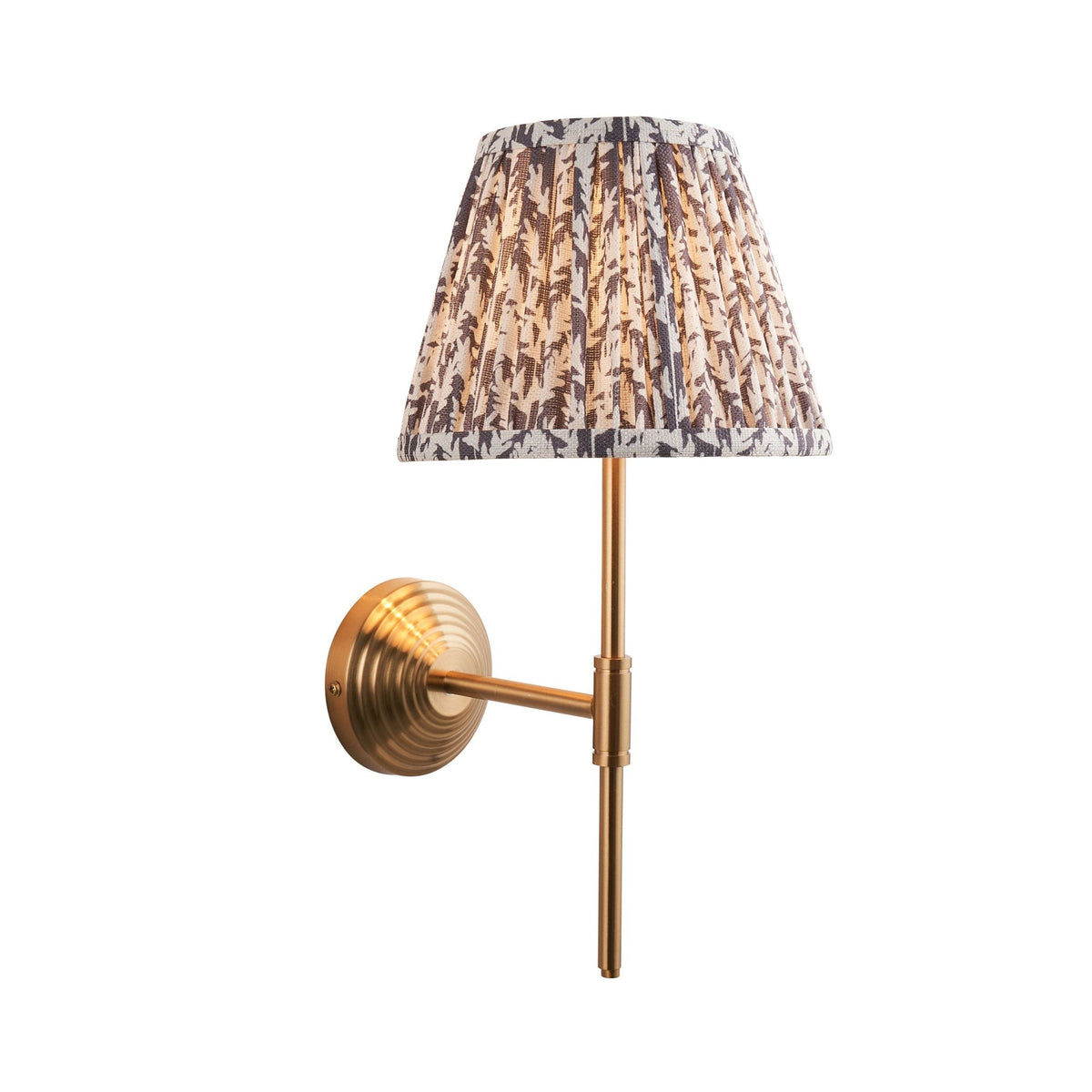 A brass wall light with a grey and white patterned pleated lampshade on a white background.