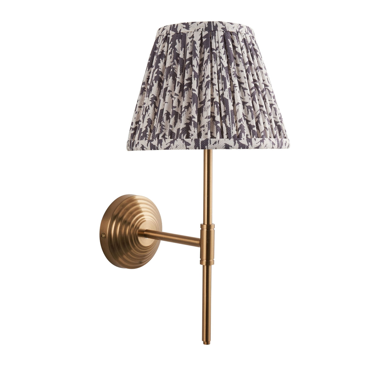 A brass wall light with a grey and white patterned pleated lampshade on a white background.