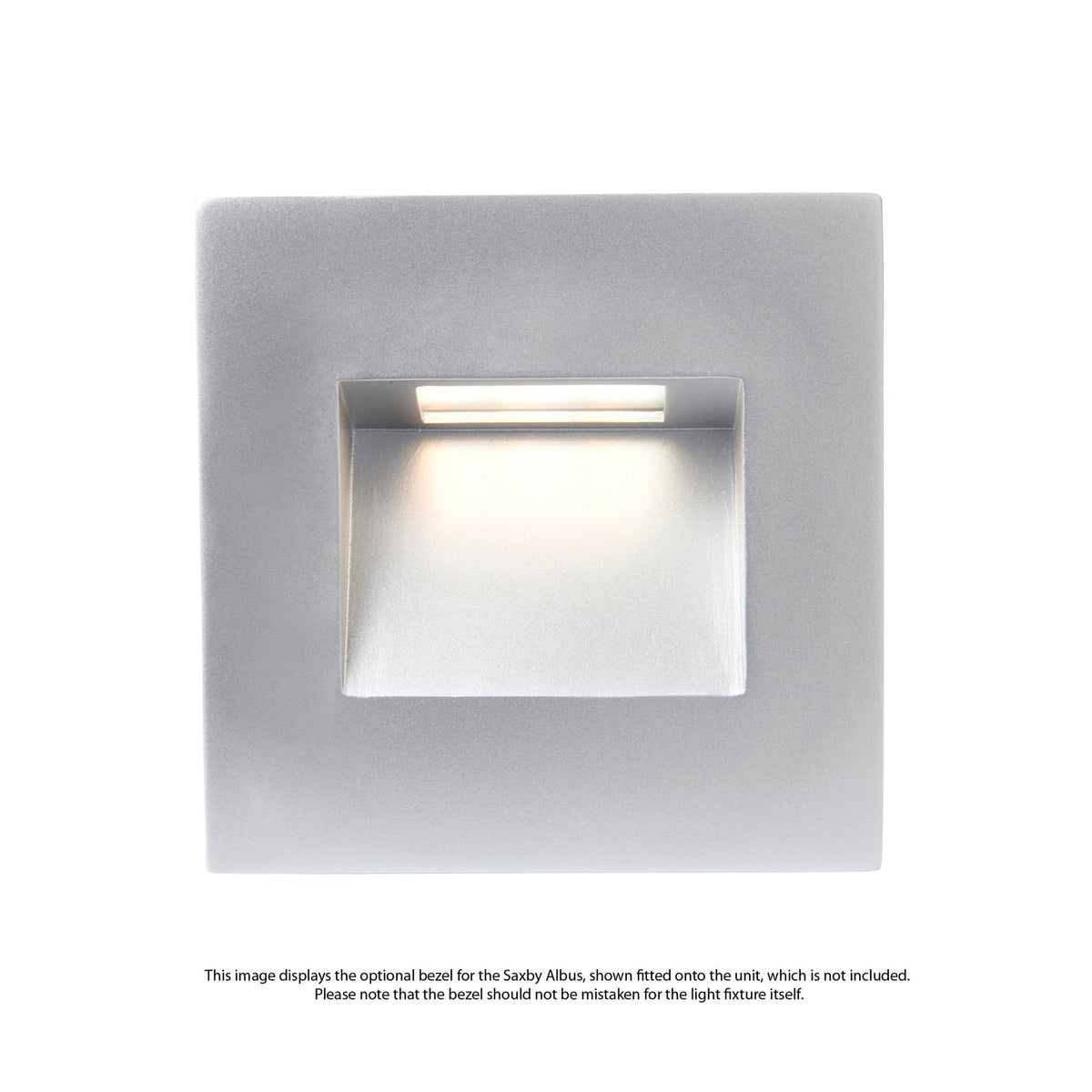 A square, silver-coloured recessed wall light with a bright white glow from its opening.