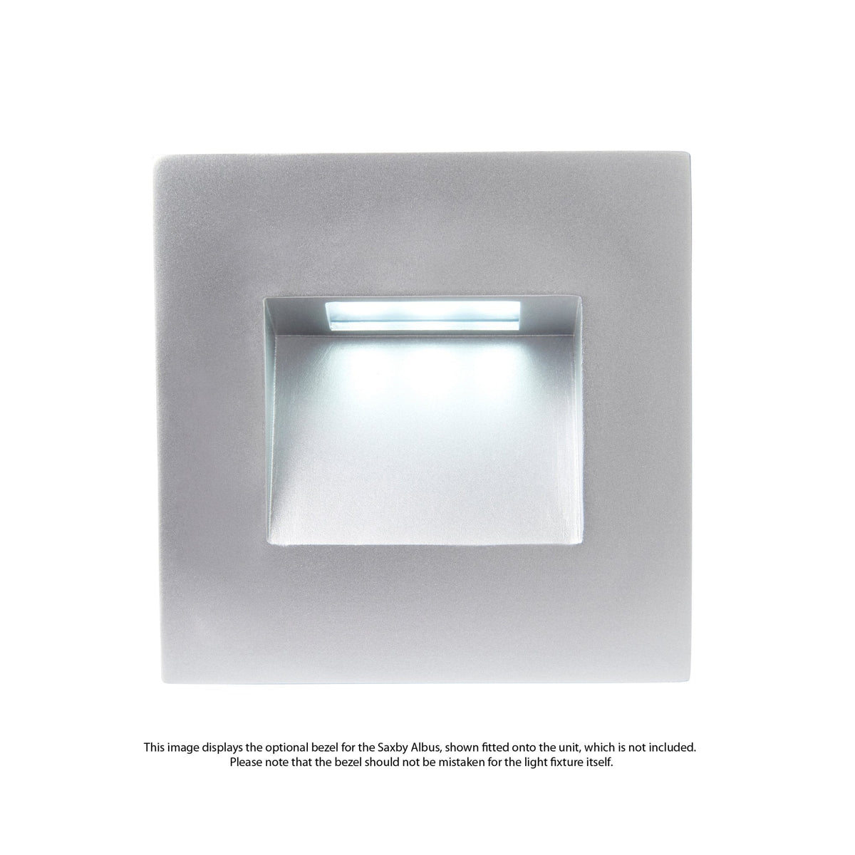 A square, silver-coloured recessed wall light with a cool blue glow from its opening.