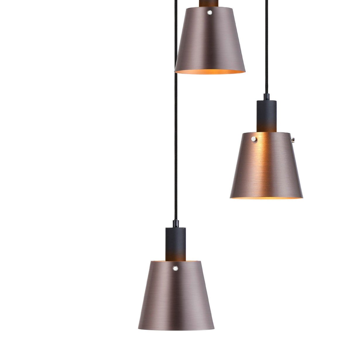 Close-up of three antique copper and black pendant lights with illuminated interiors.
