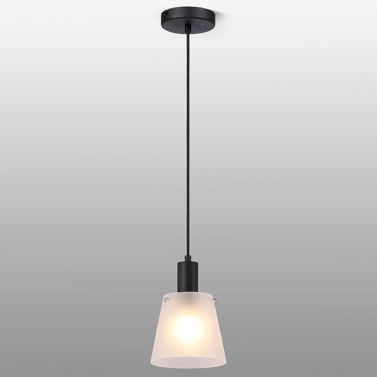 A minimalist black ceiling rose, cable, and a frosted glass pendant light against a grey backdrop.