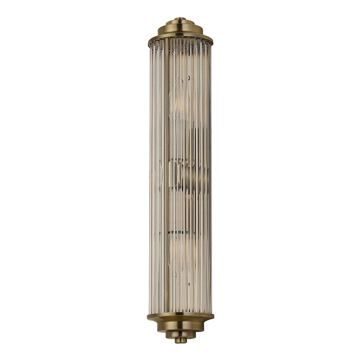 An ornate brushed brass reeded glass wall light with no illumination against a white background.
