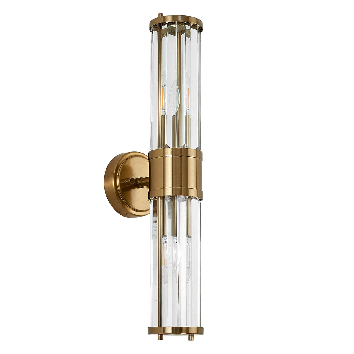 A modern brass and fluted glass wall light with unlit bulbs against a white background.