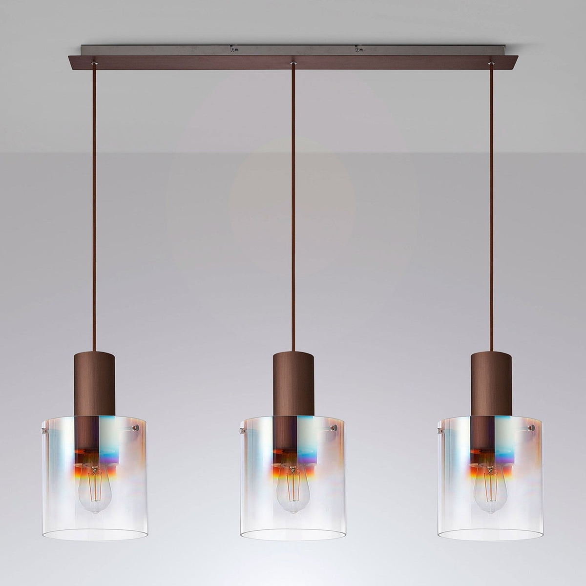 Bronze and clear glass three-light pendant fixture providing ambient lighting.