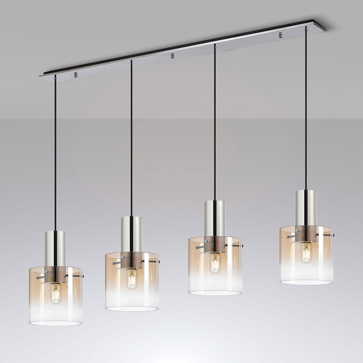 Four pendant lights with amber-tinted glass shades hang from a chrome bar, illuminating a room.