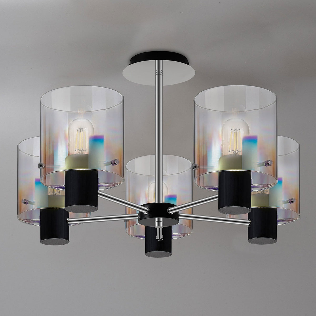 A modern five-light chandelier with clear and iridescent glass shades on a grey background.