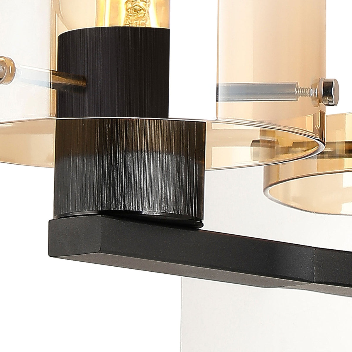 Close-up of the wall light's fitting, highlighting the textured black base and clear glass details.