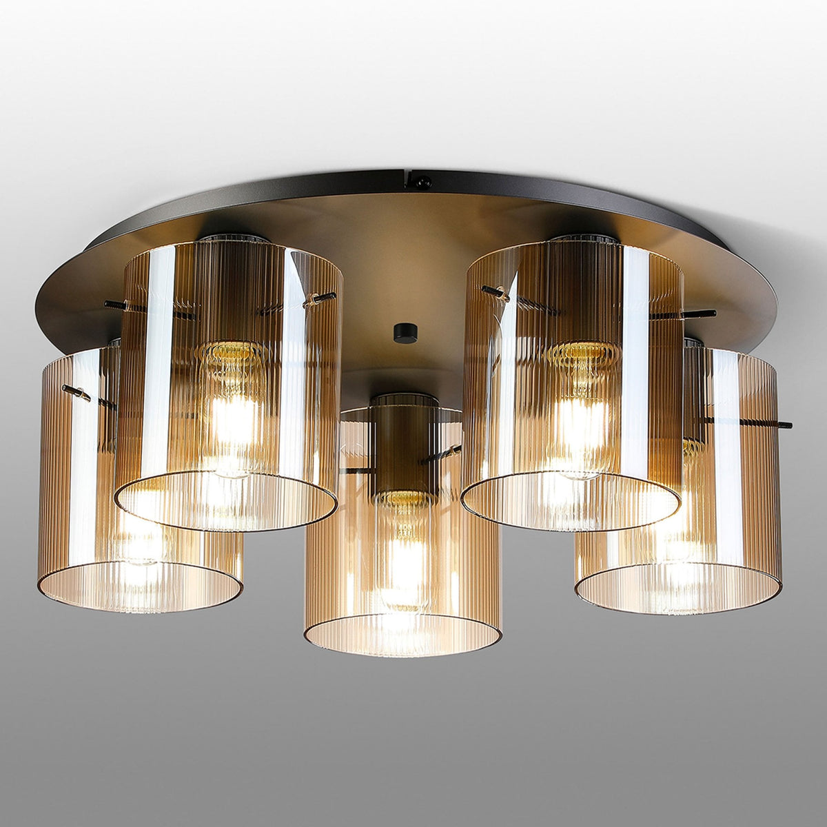 A modern five-light ceiling fitting with amber fluted glass shades.
