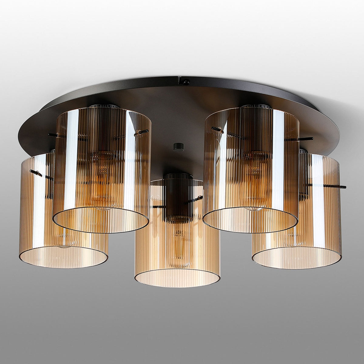 A modern five-light ceiling fitting with amber fluted glass shades.